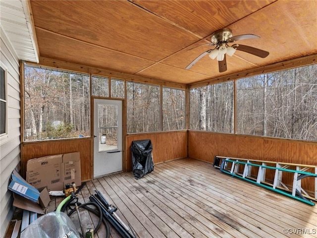 unfurnished sunroom with wood ceiling and a ceiling fan