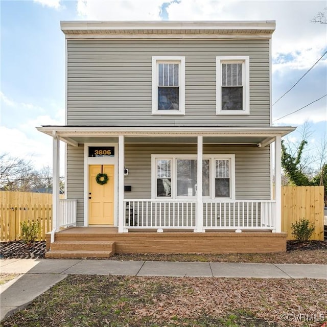 view of front of home with fence and covered porch