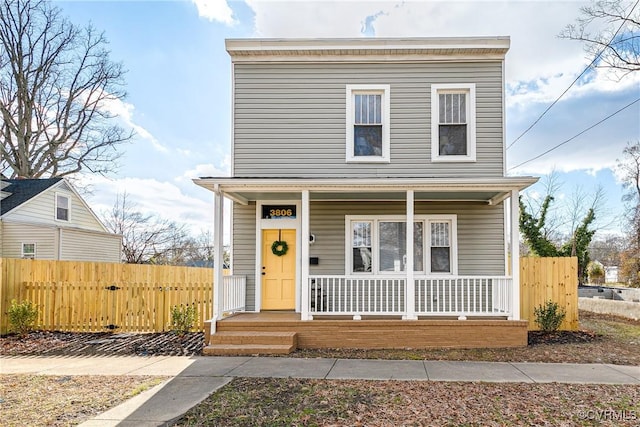 view of front of house with a porch and fence