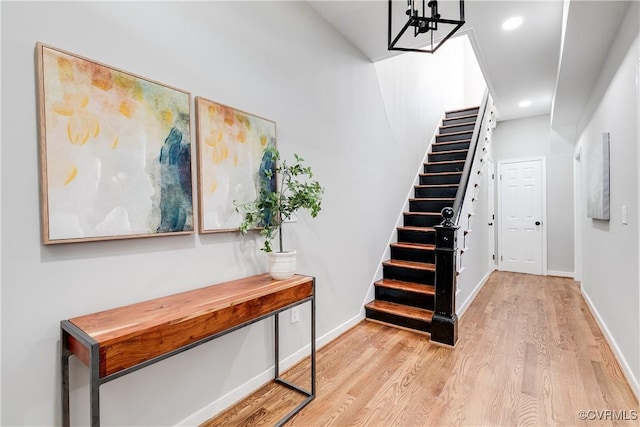 staircase featuring recessed lighting, baseboards, and wood finished floors