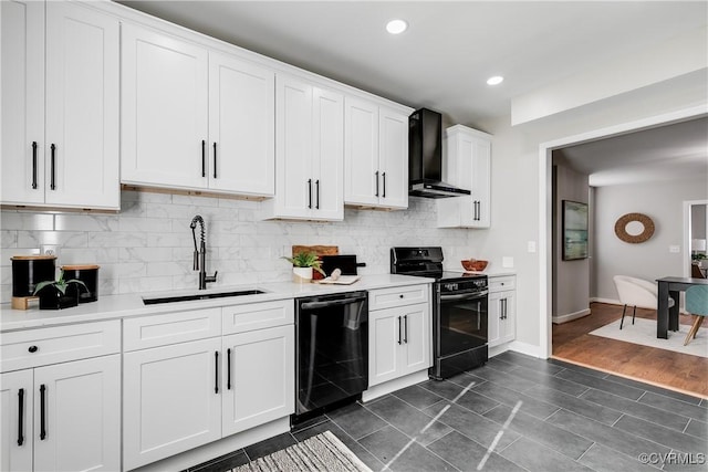 kitchen featuring a sink, black appliances, light countertops, wall chimney range hood, and backsplash