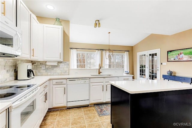 kitchen with white appliances, a sink, light countertops, white cabinets, and backsplash