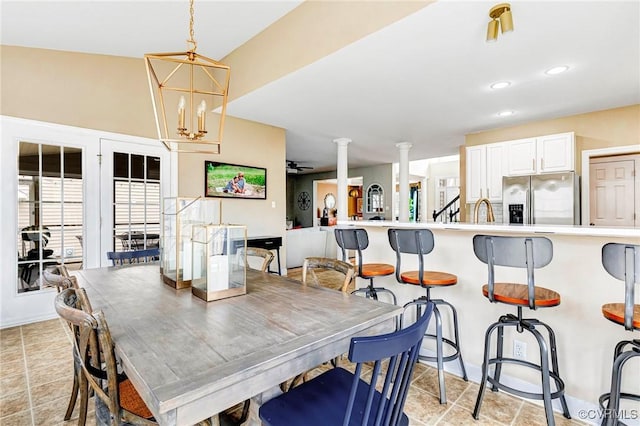 dining room featuring an inviting chandelier, decorative columns, recessed lighting, and baseboards