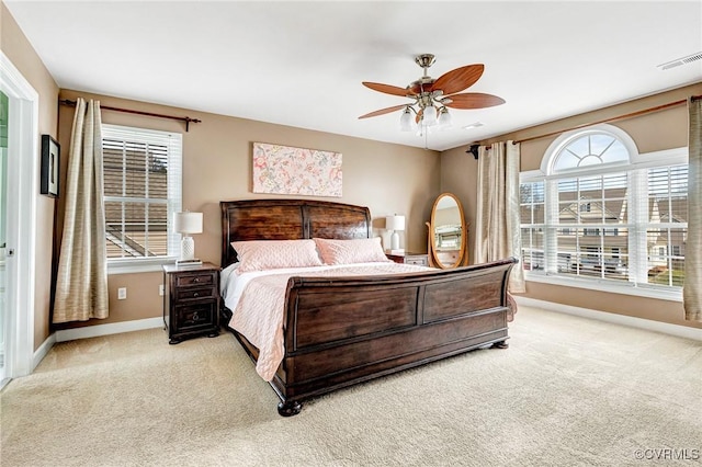 carpeted bedroom with baseboards, visible vents, and ceiling fan