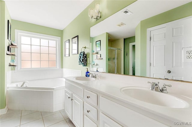 bathroom with a sink, visible vents, a bath, and tile patterned flooring