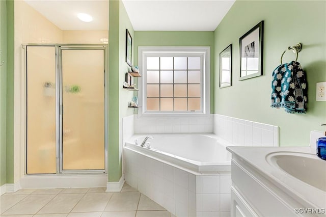 bathroom with tile patterned flooring, a bath, vanity, and a stall shower