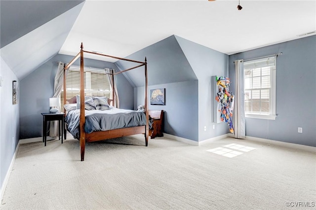 bedroom with vaulted ceiling, baseboards, visible vents, and carpet floors