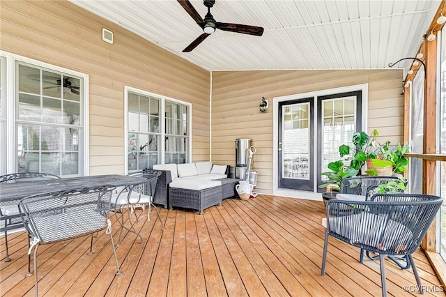 wooden terrace featuring outdoor lounge area and ceiling fan