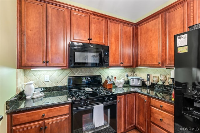 kitchen with black appliances, backsplash, and dark stone counters