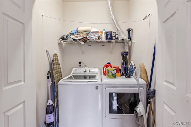 laundry area with washing machine and clothes dryer and laundry area