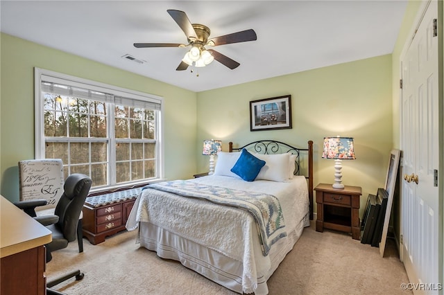 bedroom featuring ceiling fan, visible vents, a closet, and light carpet