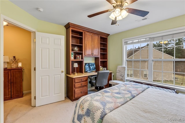 bedroom with ceiling fan, visible vents, and light carpet