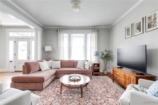 living room featuring light wood-style flooring, plenty of natural light, decorative columns, and ornamental molding