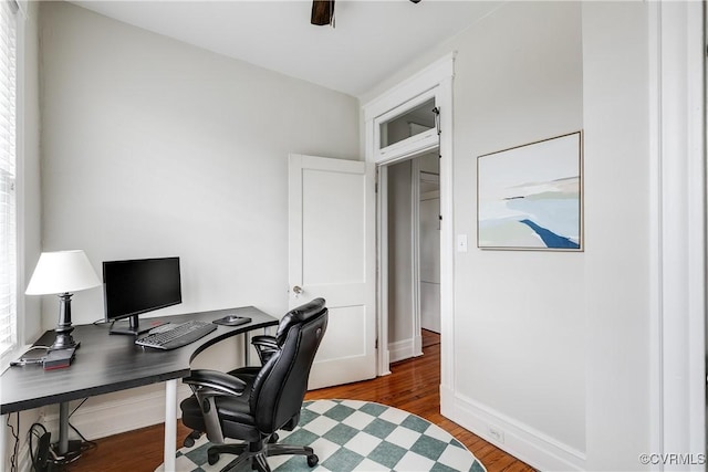 office featuring baseboards, wood finished floors, and a ceiling fan