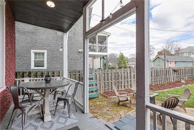 exterior space featuring outdoor dining area and fence