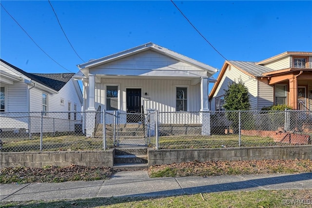 view of front of property with a porch, a gate, and a fenced front yard