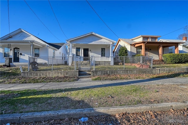 bungalow-style house featuring a fenced front yard and a porch