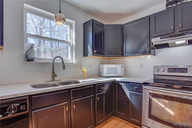 kitchen with under cabinet range hood, a sink, black dishwasher, stainless steel electric range oven, and white microwave