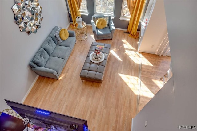 living area featuring baseboards and wood finished floors