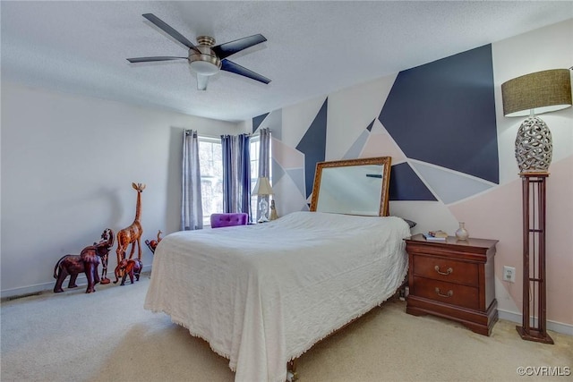 carpeted bedroom featuring baseboards, visible vents, a textured ceiling, and ceiling fan