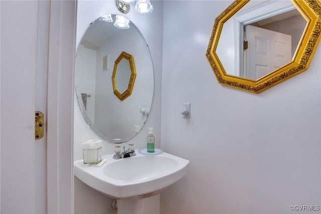 bathroom featuring visible vents and a sink