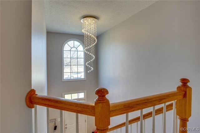 details featuring an inviting chandelier and a textured ceiling