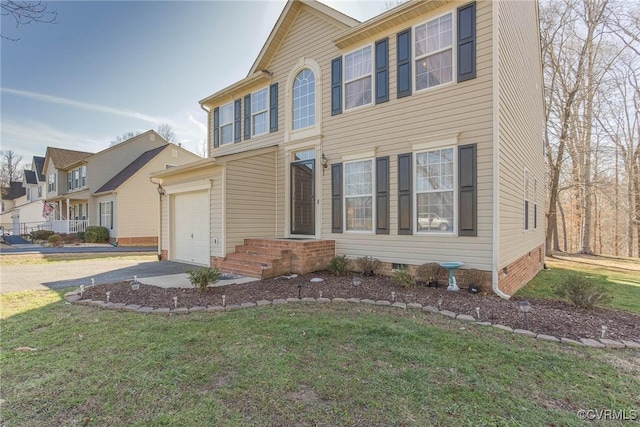 colonial inspired home featuring crawl space, a garage, driveway, and a front lawn