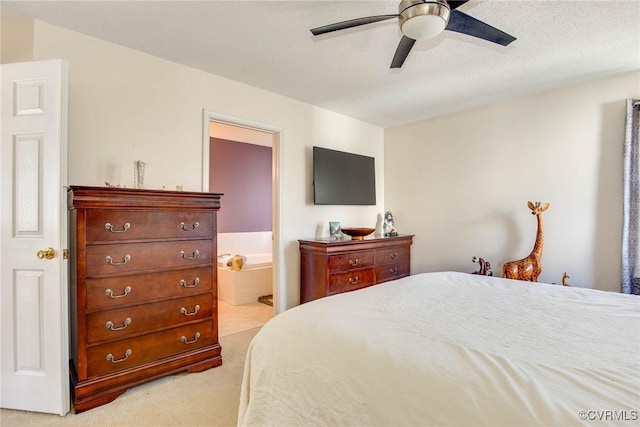 bedroom with connected bathroom, light carpet, and ceiling fan