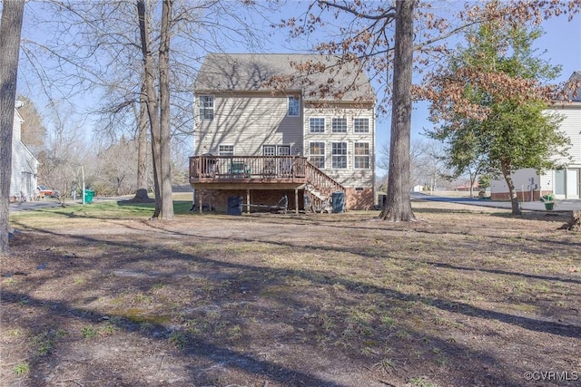 rear view of property with a wooden deck and stairs