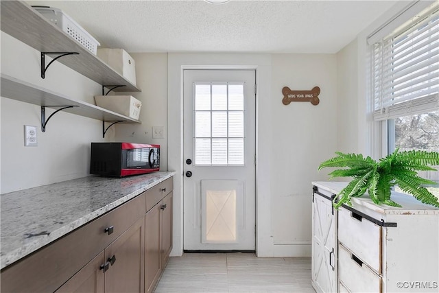 doorway with a textured ceiling