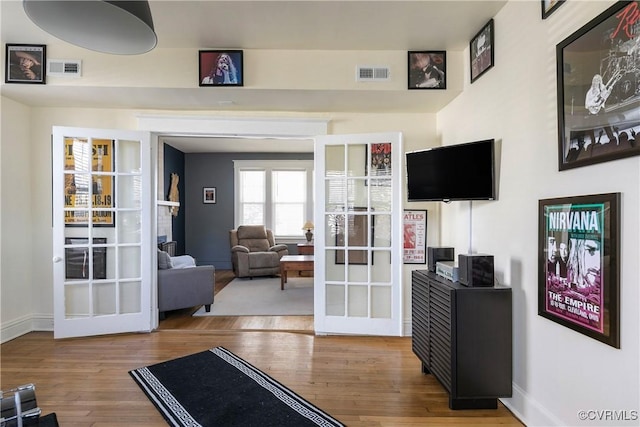 interior space with visible vents, wood finished floors, and french doors