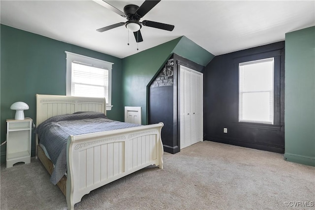 bedroom featuring baseboards, light colored carpet, and a ceiling fan