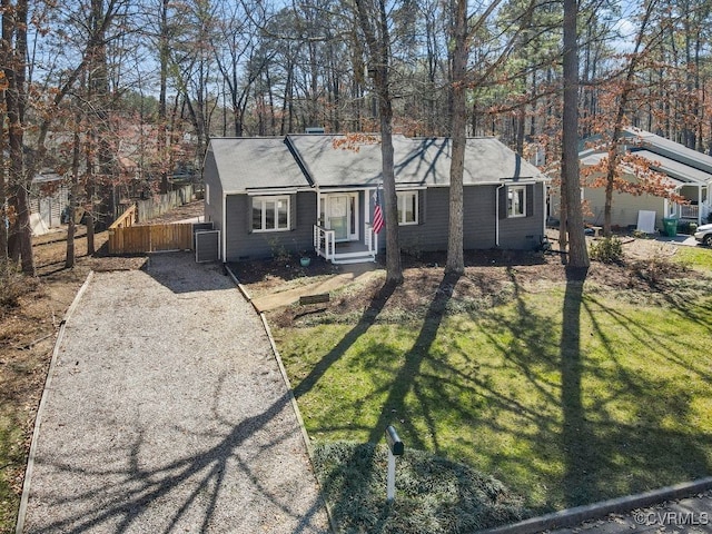 single story home with driveway, a front lawn, and fence