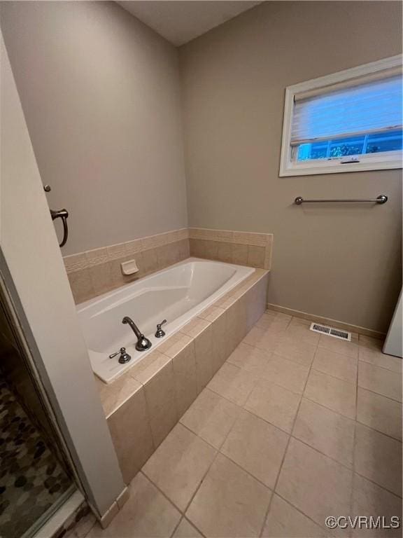 full bathroom featuring visible vents, a garden tub, and tile patterned flooring