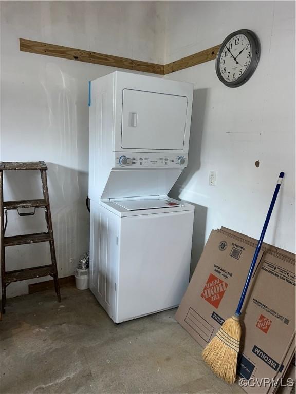 laundry room with laundry area and stacked washer / dryer