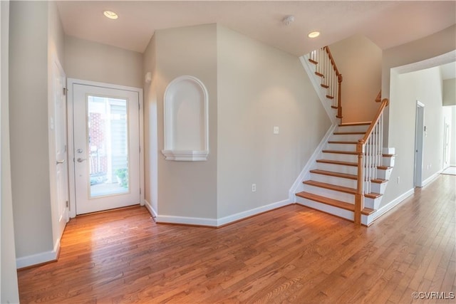 entryway featuring stairway, recessed lighting, baseboards, and wood finished floors