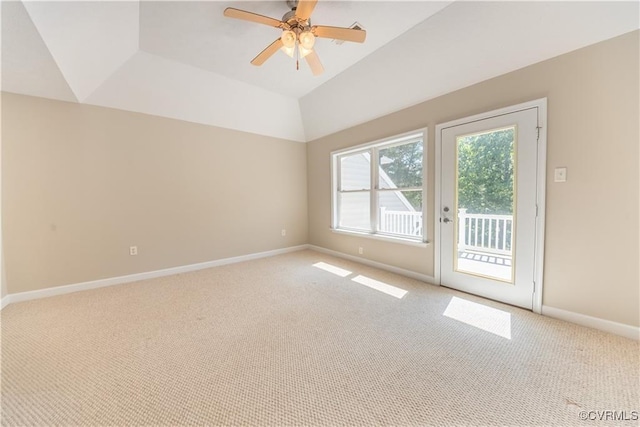 empty room with baseboards, light carpet, ceiling fan, and vaulted ceiling