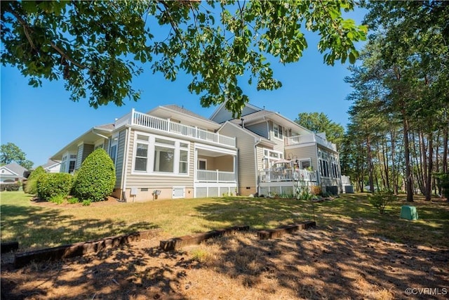 rear view of property with crawl space and a yard