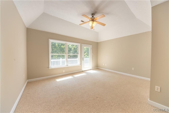 empty room featuring visible vents, lofted ceiling, baseboards, light colored carpet, and ceiling fan