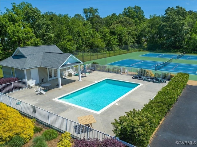 community pool with an exterior structure, a patio area, french doors, and fence