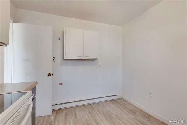 interior space with white cabinetry, light wood-style flooring, baseboard heating, and white range with electric cooktop