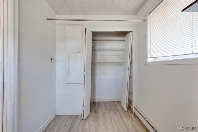 closet with a baseboard heating unit