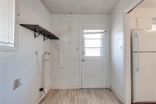 laundry area with laundry area, electric panel, and light wood finished floors