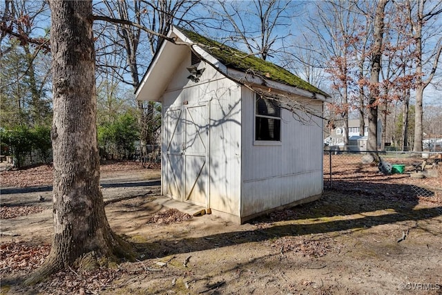 view of shed with fence