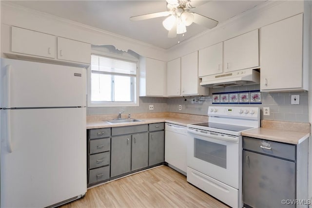 kitchen with white appliances, gray cabinets, a sink, white cabinets, and under cabinet range hood