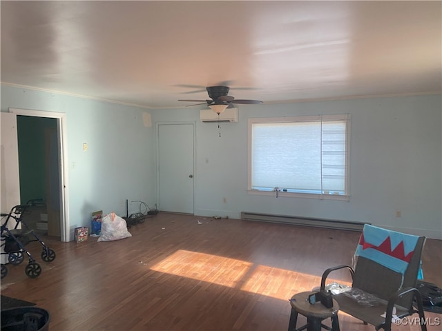 living room featuring baseboard heating, crown molding, a wall mounted AC, and wood finished floors