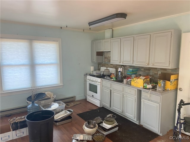 kitchen with a baseboard heating unit, white gas range oven, white cabinetry, light countertops, and decorative backsplash