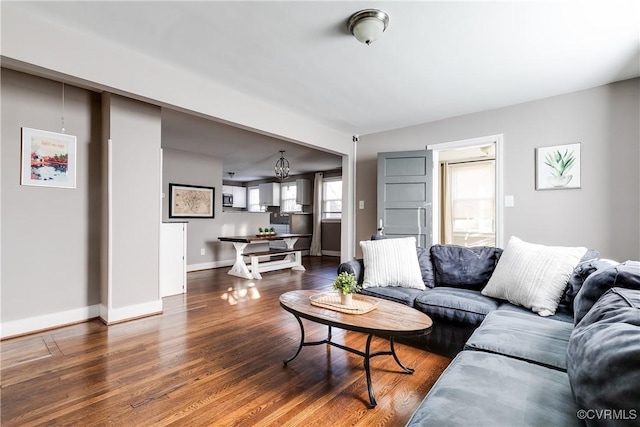 living room with baseboards and wood finished floors