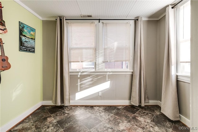 unfurnished room featuring visible vents, stone finish flooring, and baseboards