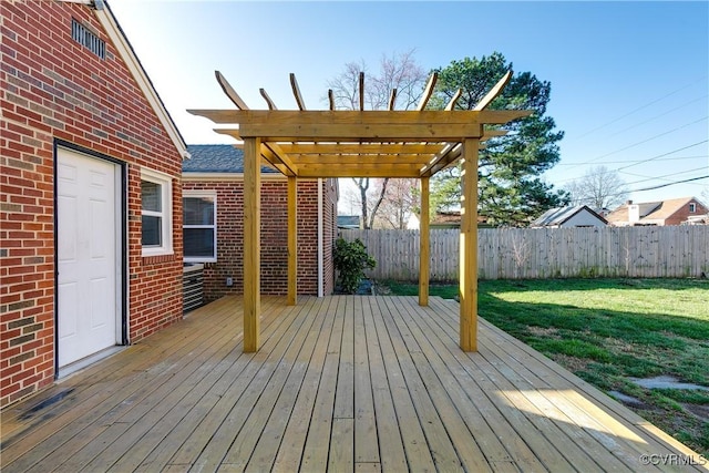 wooden deck with a lawn, a pergola, and fence